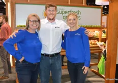 Cat Gipe-Stewart, Tyler Weinbender and Brena Whipple with Domex Superfresh Growers show a big smile for the camera.